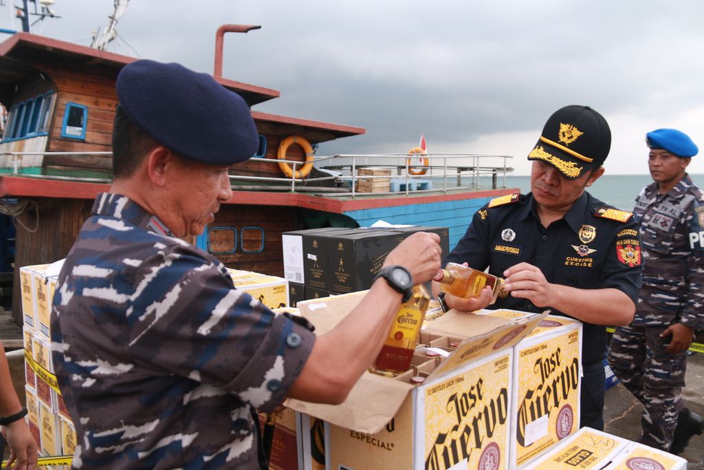 Petugas Bea dan Cukai serta TNI Angkatan Laut memeriksa minuman beralkohol yang diangkut secara ilegal kapal tanpa nama di Batam, Kepulauan Riau, Jumat (21/10/2022).