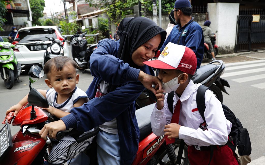 Seorang siswa berpamitan kepada ibunya saat tiba di SD Negeri Joglo 05, Kembangan, Jakarta Barat, Senin (30/1/2023). Orangtua yang mengantar dan menjemput anak mereka saat pulang sekolah merupakan salah satu upaya mencegah tindakan kriminal penculikan.