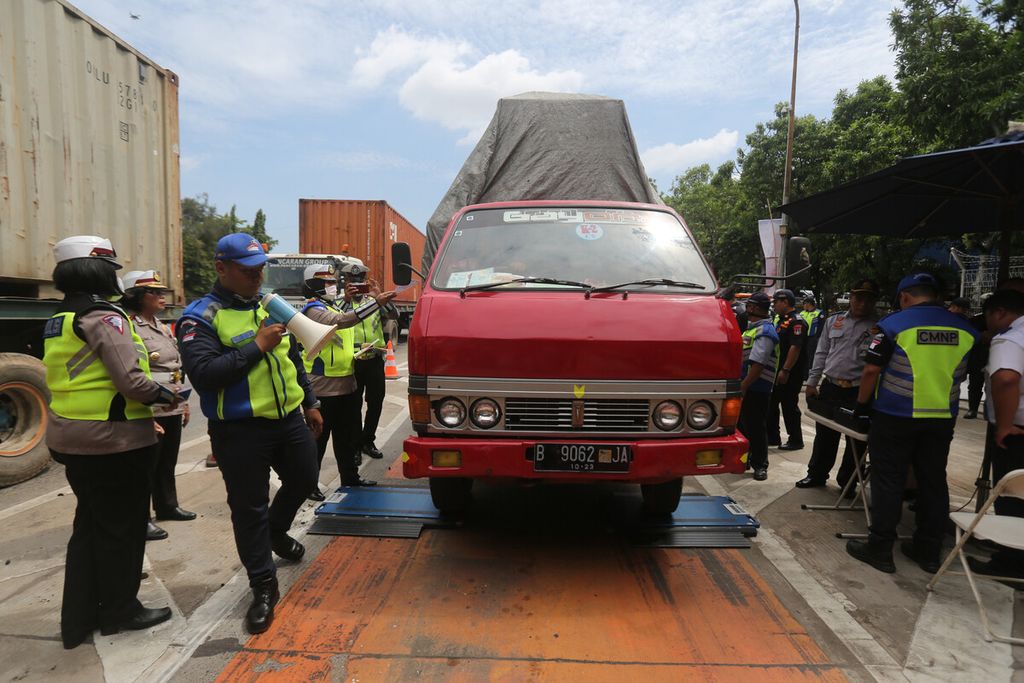 Petugas mengukur berat truk saat mengadakan razia terhadap truk angkutan di pintu Tol Tanjung Priok 1, Koja, Jakarta Utara, Senin (9/3/2020). 