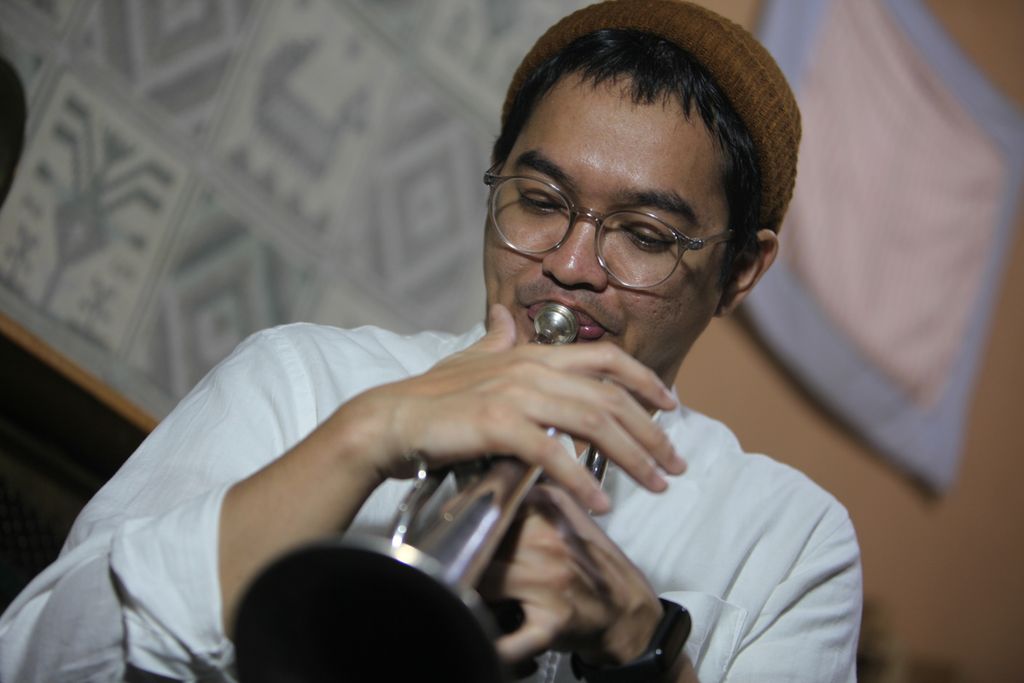  Tesla Manaf alias Kuntari meniup instrumen kornet di studionya di Awiligar, Kota Bandung.