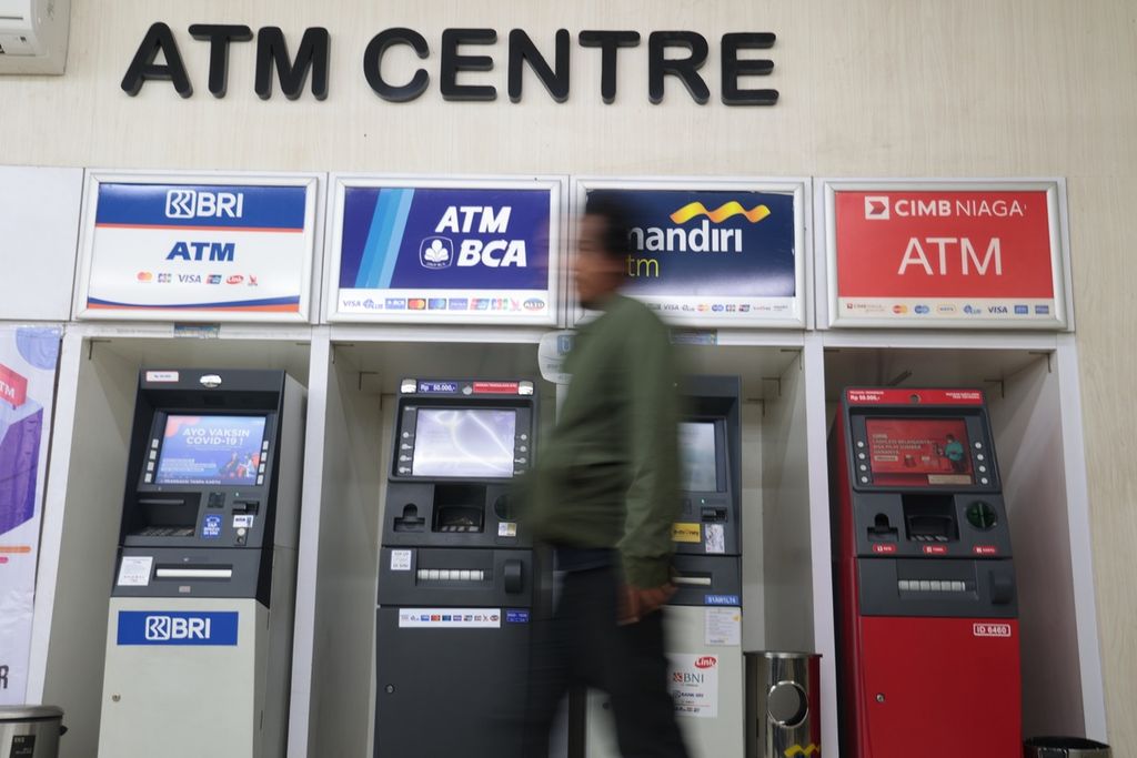 Warga memanfaatkan ATM untuk bertransaksi elektronik ataupun mengambil uang di kawasan Pasar Minggu, Jakarta, Senin (9/1/2023).  