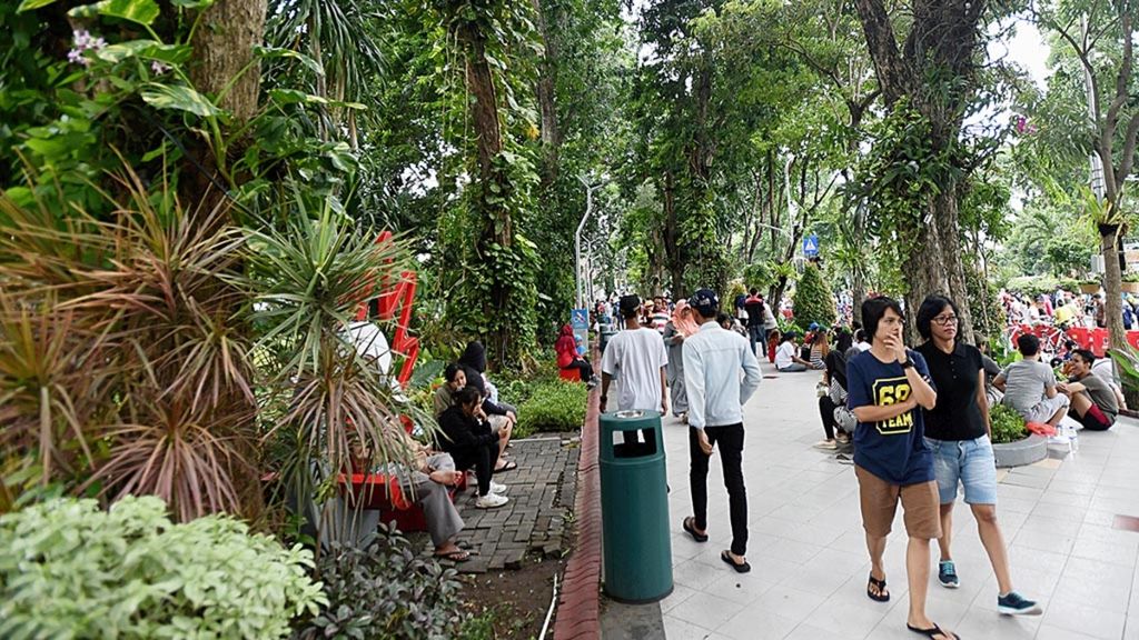 Warga bersantai di Taman Bungkul, Surabaya, Jawa Timur, Minggu (27/1/2019). Kenyamanan dan fasilitas bermain yang cukup lengkap membuat Taman Bungkul tidak pernah sepi dari pengunjung.
