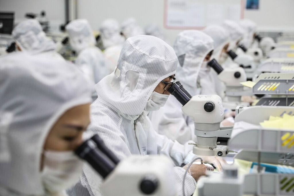 Para pekerja memproduksi cip LED di sebuah pabrik di Huaian, Provinsi Jiangsu, China timur, 16 Juni 2020.