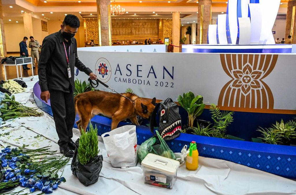 Security personnel use a bomb sniffer dog during an inspection tour of a hotel as part of security measures for the upcoming ASEAN summit in Phnom Penh on November 7, 2022. (Photo by TANG CHHIN SOTHY / AFP)