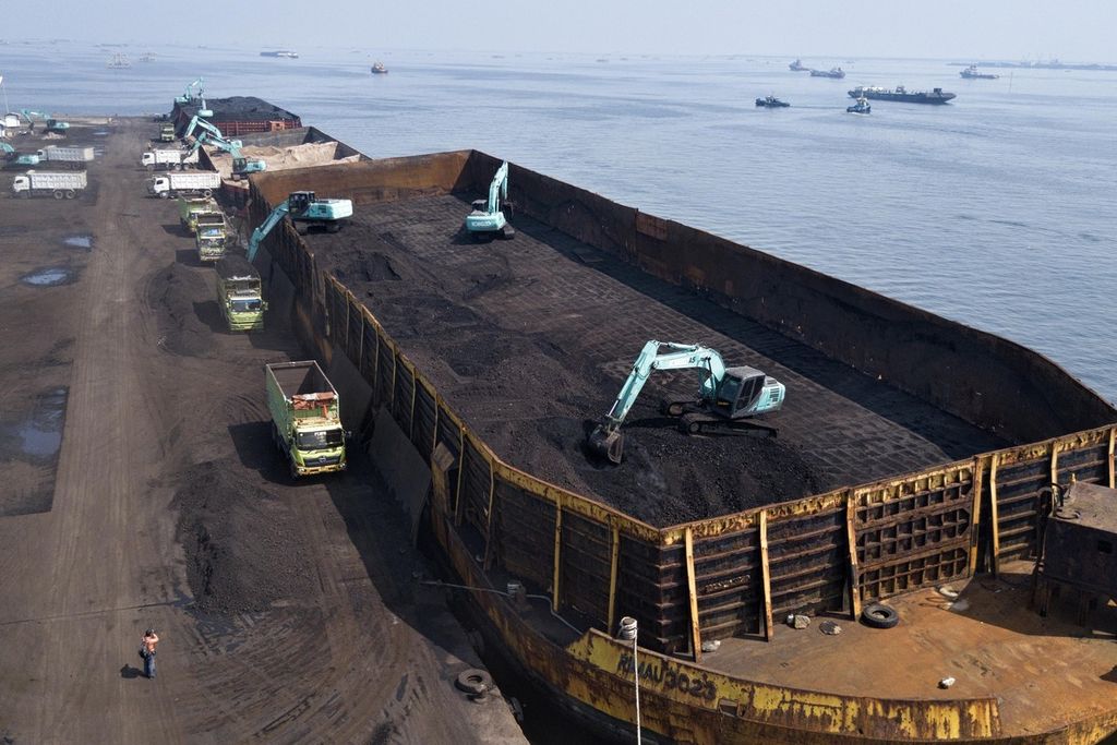 Ekskavator memindahkan batubara dari dalam tongkang ke atas truk di Pelabuhan KCN Marunda, Jakarta Utara, Rabu (5/1/2022). 