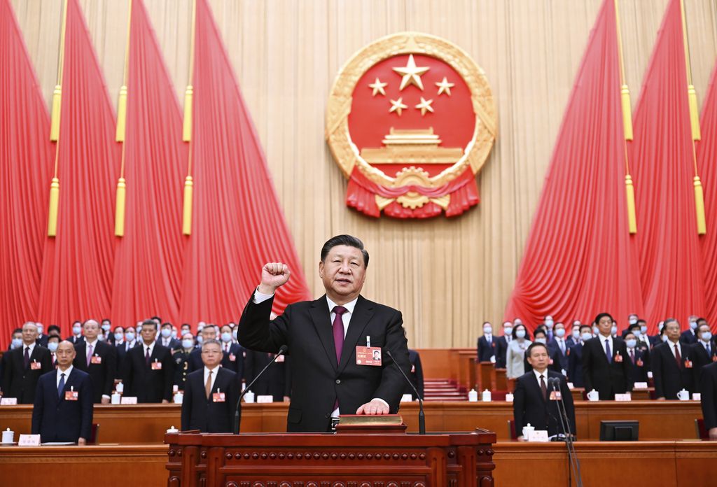 In this photo released by Xinhua News Agency, Chinese President Xi Jinping takes his oath after he is unanimously elected as President during a session of China's National People's Congress (NPC) at the Great Hall of the People in Beijing, Friday, March 10, 2023. Chinese leader Xi Jinping was awarded a third five-year term as president on Friday, putting him on track to stay in power for life. 