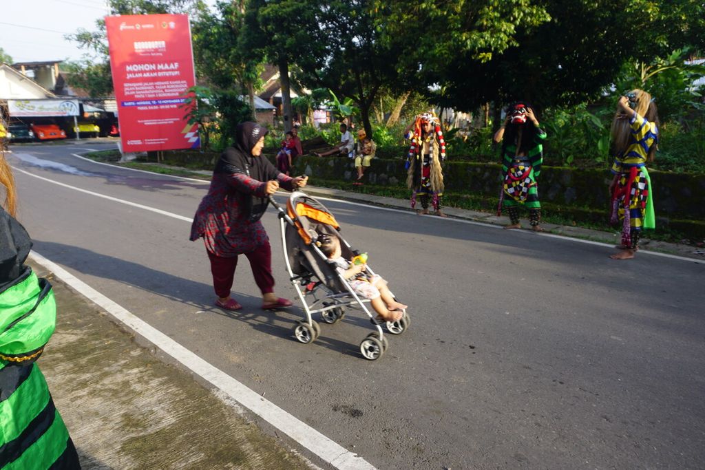 Seorang ibu mendorong kereta bayi di lintasan Borobudur Marathon 2022 Powered by Bank Jateng, Sabtu (12/11/2022).