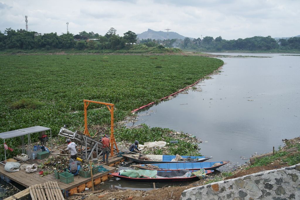 Petugas dengan bantuan ban berjalan atau <i>conveyor belt </i>mengangkat sampah dari air Sungai Citarum di Waduk Saguling, Kabupaten Bandung Barat, Jawa Barat, seperti yang terlihat pada Selasa (7/2/2023).