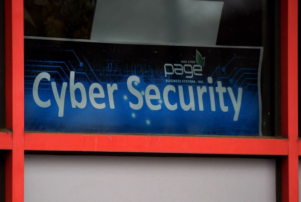  In this file photo a “Cyber Security” sign is displayed in the window of a computer store on December 18, 2020, in Arlington, Virginia. – A White House cybersecurity gathering including Big Tech executives was set on August 25, 2021 to unveil steps aimed at improving cybersecurity following high-profile attacks which raised questions about the vulnerability of so-called critical infrastructure. President Joe Biden and key cabinet officials were to host the chief executives of Apple, Google, Amazon and Microsoft along with leaders from the finance and utilities sectors, a senior administration official said. 