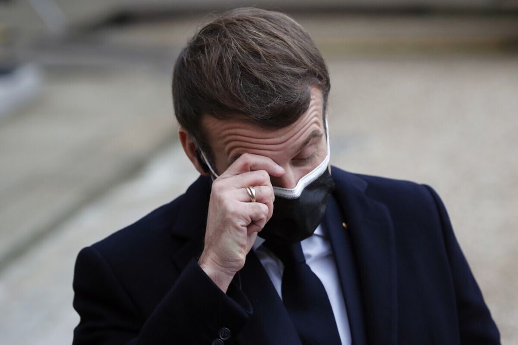 French President Emmanuel Macron reacts as he listen to the speech of Portuguese Prime Minister Antonio Costa, Wednesday, Dec. 16, 2020 in Paris. French President Emmanuel Macron has tested positive for COVID-19, the presidential Elysee Palace announced on Thursday. (AP Photo/Francois Mori)