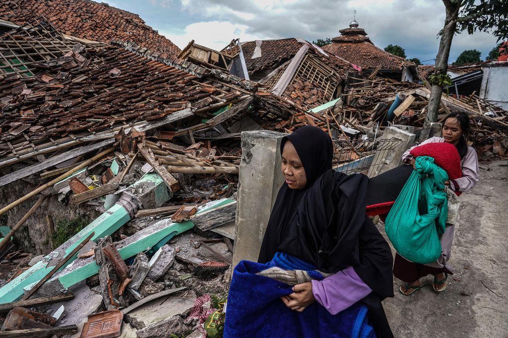 Warga membawa harta bendanya menuju pengungsian di Cugenang, Kabupaten Cianjur, Jawa Barat, Selasa (22/11/2022). Kondisi kerusakan akibat gempa yang melanda Cianjur pada Senin (22/11/2022) terlihat pada sejumlah wilayah desa yang terdampak.