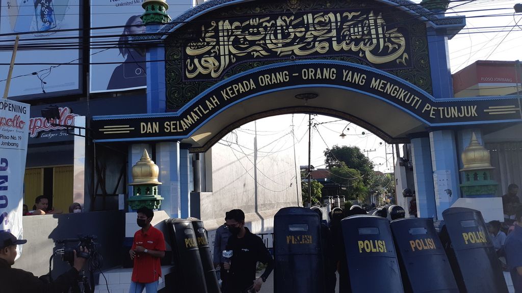 Polisi berjaga di pintu masuk Pesantren Shiddiqiyah, Jombang, Kamis (7/7/2022). Ratusan personel dikerahkan untuk menangkap pelaku kekerasan seksual terhadap santri MSA yang merupakan putra pengasuh pondok.