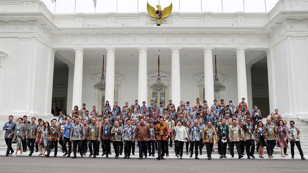 Presiden Joko Widodo beserta peserta Kompas100 CEO Forum <i>powered by</i> East Ventures berjalan seusai foto bersama di depan Istana Merdeka, Jakarta, Jumat (2/12/2022).