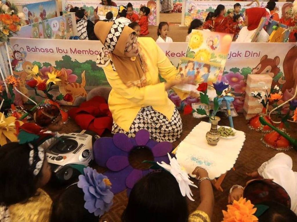Seorang guru PAUD membacakan buku cerita berbahasa ibu kepada siswa dalam Festival dan Kreativitas Anak Usia Dini 2017 bertema Bahasa Ibu Membangun Keadaban Keaksaraan sejak Dini di Jakarta, Rabu (10/5).