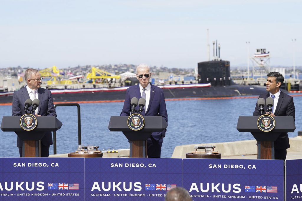 Perdana Menteri Australia Anthony Albanese (kiri), Presiden Amerika Serikat Joe Biden, dan PM Inggris Rishi Sunak (kanan) dalam pertemuan pemimpin negara aliansi militer yang dikenal sebagai AUKUS pada 13 Maret di pangkalan laut San Diego, California. Selepas pertemuan itu, mereka mengumumkan Australia akan membeli hingga tiga kapal selam bertenaga nuklir dari AS dan Inggris.