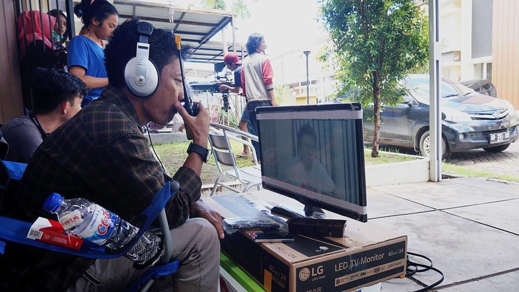 Andi Burhamzah (27), sutradara film, mengecek persiapan sebelum melanjutkan pengambilan gambar untuk <i>shooting </i>film <i>Cindolo na Tape (Cinta)</i>, di Tanjung Bunga, Makassar, Sulawesi Selatan, Rabu (15/2/2017). Industri film di Makassar sedang bergeliat beberapa tahun terakhir. Puluhan rumah produksi, belasan judul film, sejumlah sineas muda, dan miliaran rupiah lahir dari industri kreatif ini.