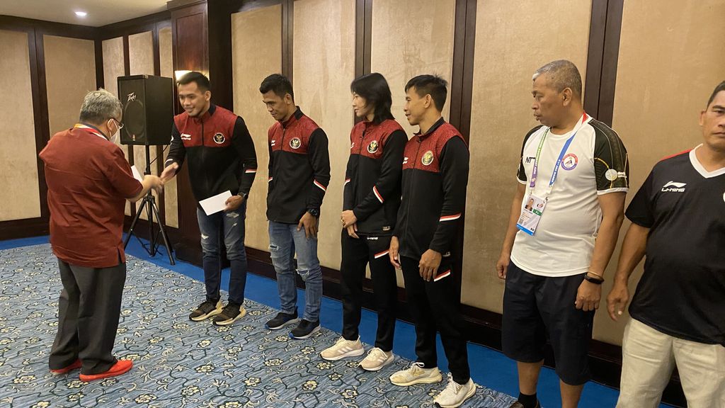 Ketua umum PB PGSI Trimedya Panjaitan (kiri) memberikan uang saku untuk para atlet gulat dan pelatih seusai berlaga di SEA Games Vietnam 2021, Kamis (19/5/2022) malam. 