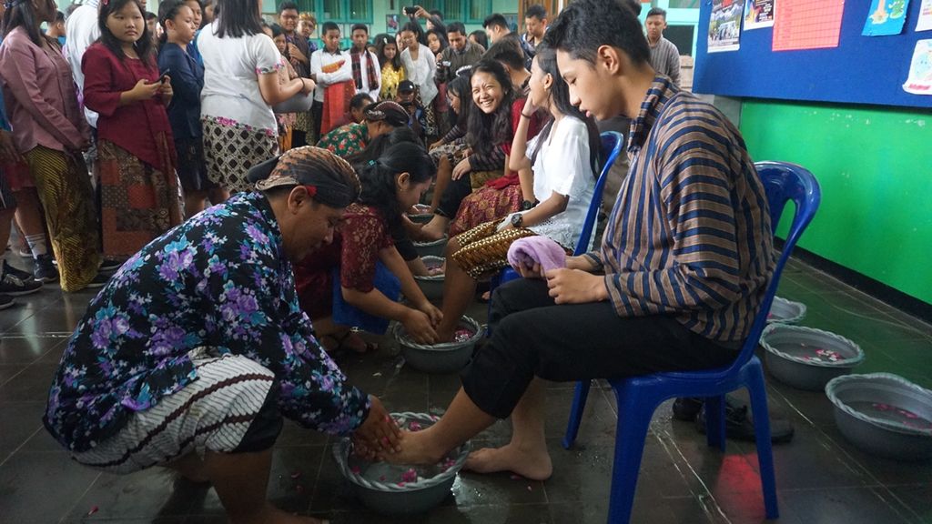 Guru membasuh kaki muridnya di SMP Pius, Cilacap, Jawa Tengah, Senin (25/11/2019). Guru dan murid saling bergantian membasuh kaki dalam peringatan Hari Guru Nasional sebagai simbol kerendahan hati dan saling menghormati.