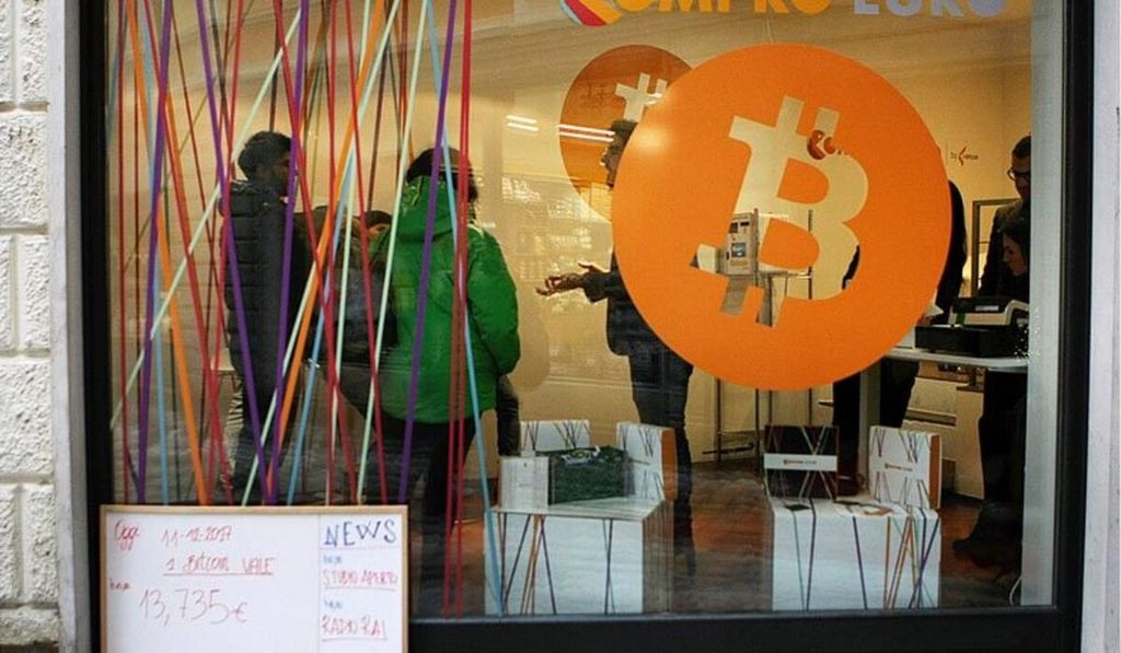 A picture shows the first Italian Bitcoin crypto currency shop "Bitcoin Compro Euro" (meaning I Buy Euro), on December 11, 2017 in Rovereto, northern Italy. Bitcoin surged past $18,000 after making its debut on a major global exchange but was trading lower on December 11, 2017, highlighting the volatility of the controversial digital currency that has some investors excited but others nervous.