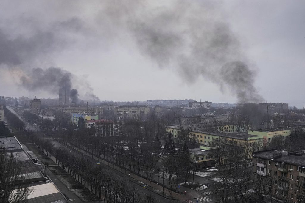 Asap mengepul usai penembakan di Mariupol, Ukraina, Rabu (9/3/2022). Mariupol adalah kota pelabuhan berpenduduk 400.000 orang yang dikepung dan dibombardir oleh pasukan Rusia.