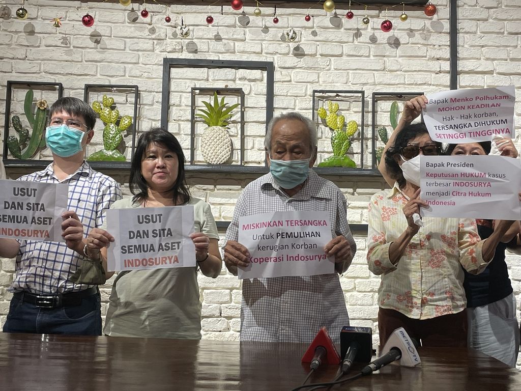 Para korban kasus gagal bayar Koperasi Simpan Pinjam Indosurya menunjukkan poster saat konferensi pers di Jakarta, Minggu (18/12/2022). Mereka menuntut majelis hakim memutuskan agar aset terdakwa yang disita dikembalikan ke mereka, alih-alih diserahkan ke negara.