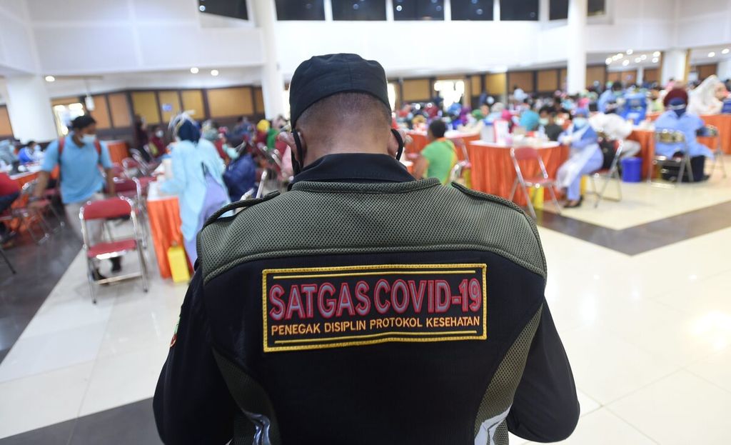 Petugas berjaga saat vaksinasi Covid-19 massal di Convention Hall, Surabaya, Jawa Timur, Kamis (4/3/2021). Vaksinasi terus dilakukan di Kota Surabaya. Sebanyak 3.590 petugas Organisasi Perangkat Daerah (OPD) mengikuti vaksinasi massal tersebut. 