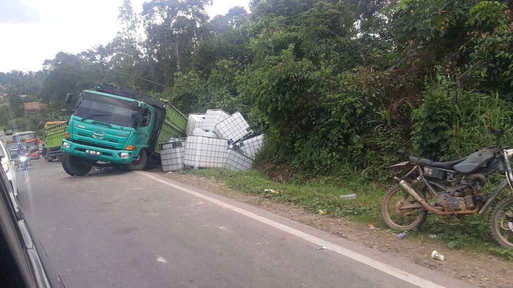 Kecelakaan truk yang terperosok di Kecamatan Tungkal Jaya, Kabupaten Musi Banyuasin, Sumatera Selatan, Minggu (1/1/2022). Kecelakaan kerap terjadi di jalur ini karena kondisi jalan yang bergelombang atau berlubang. Hal ini juga disebabkan truk yang mengangkut barang melebihi kapasitas semestinya.