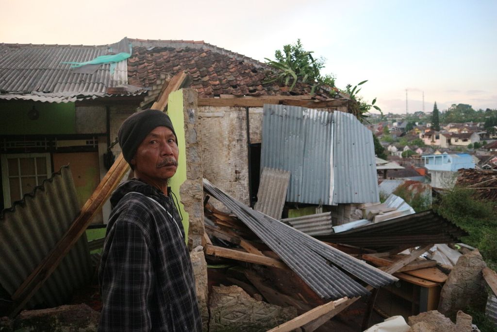 Ihya, Ketua RT 03 RW 03 Desa Cibeureum, Cugenang, Cianjur, Jawa Barat, menunjukkan rumah seorang warganya yang roboh akibat gempa, Senin (21/11/2022). 