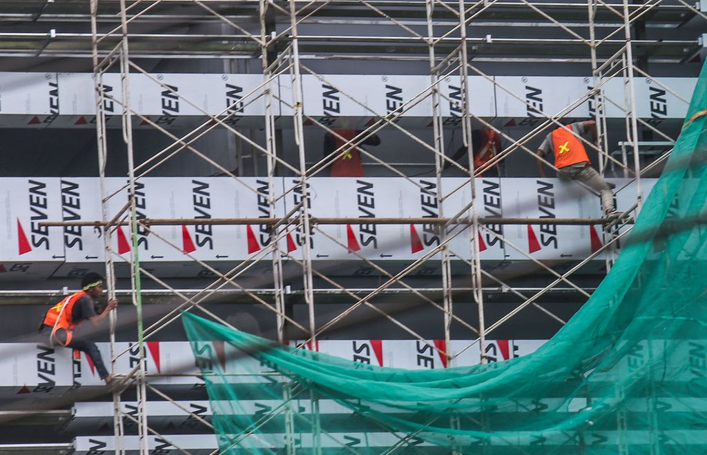 Para pekerja dengan risiko kerja tinggi bergelantungan menyelesaikan proyek konstruski sebuah gedung di kawasan Karang Tengah, Jakarta, Rabu (17/11/2021).