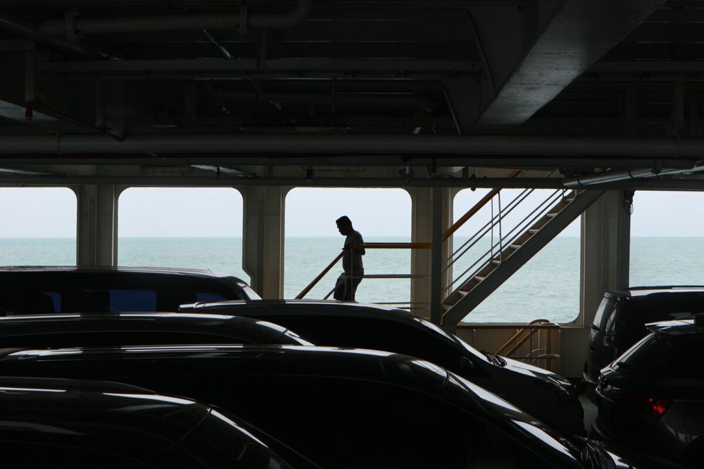Seorang penumpang sedang turun ke lantai bagian bawah kapal feri tempat mobil para penyeberang diparkirkan. Kapal feri tersebut sedang melewati Selat Sunda, dari Merak ke Bakauheni pada Jumat (23/12/2022)