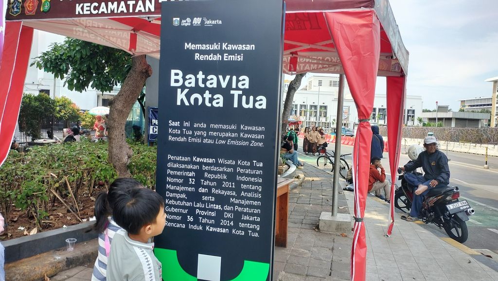 Anak kecil mengamati papan informasi kawasan rendah emisi di Kota Tua, Taman Sari, Jakarta Barat, Sabtu (22/10/2022).
