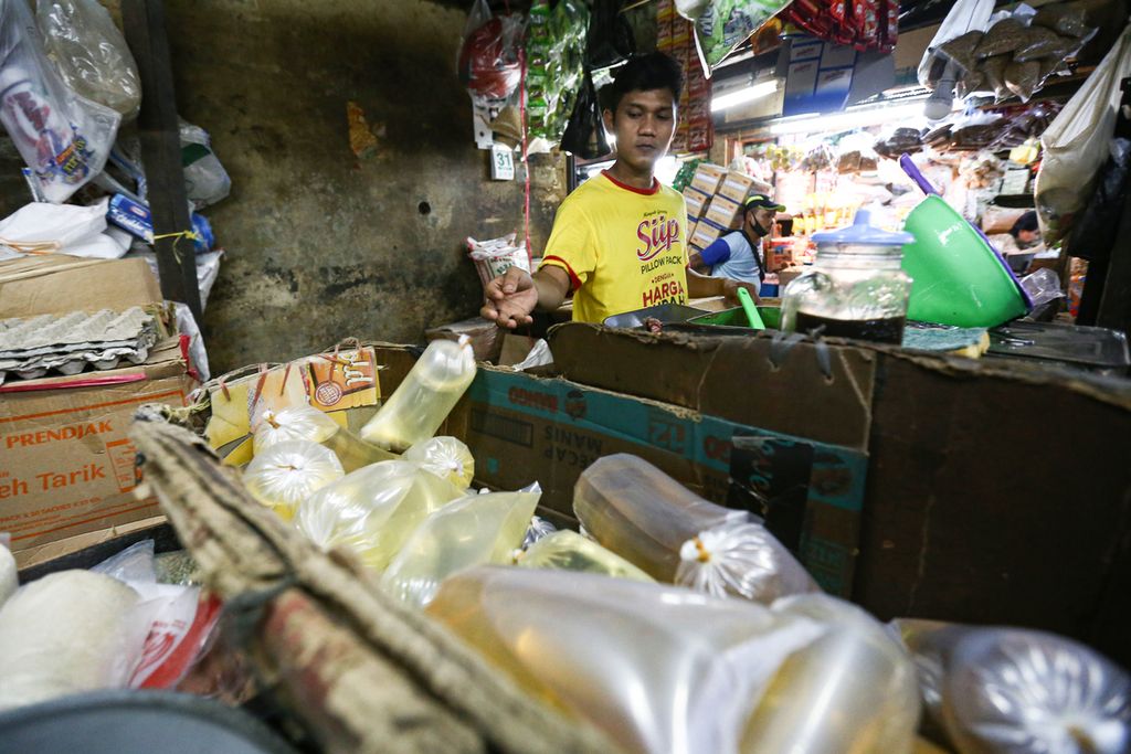 Pekerja mengemas minyak goreng curah di Pasar Kebayoran Lama, Jakarta Selatan, Senin (30/1/2022). Minyak goreng curah dijual di pasar tersebut dengan harga Rp 20.000 per kilogram. 