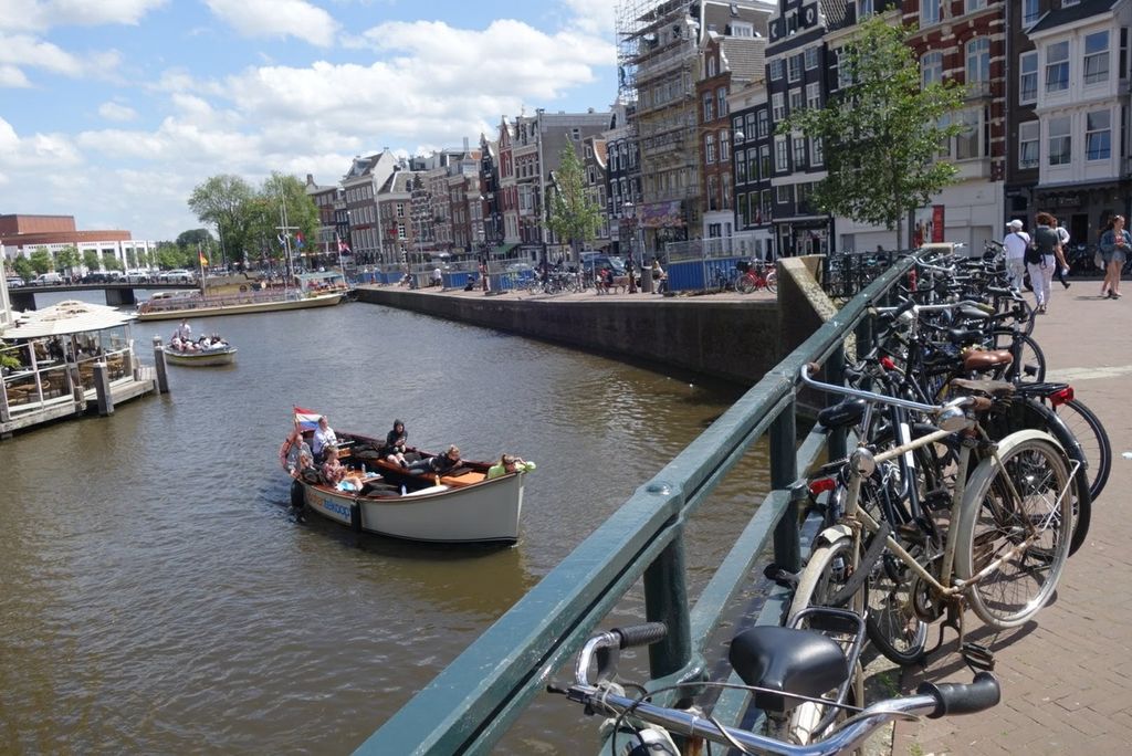 Sepeda, kanal, perahu, dan deretan bangunan khas di Kota Amsterdam, Belanda. Kota ini dijuluki ibu kota sepeda dunia. Foto diambil pada Juli 2019.