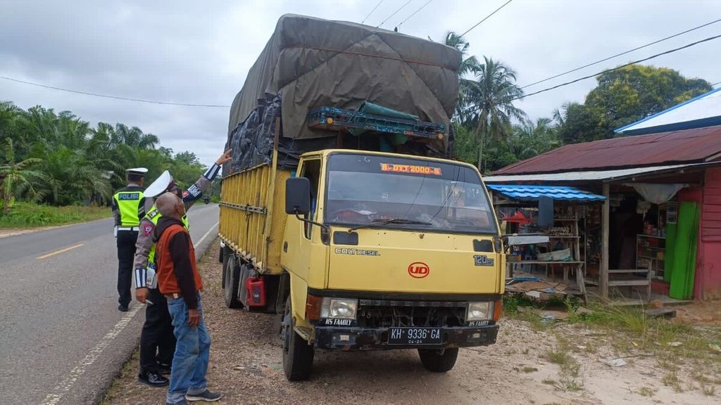 Aparat kepolisian daerah menilang sebuah kendaraan yang kelebihan muatan di Palangkaraya, Kalimantan Tengah, Rabu (20/4/2022). 