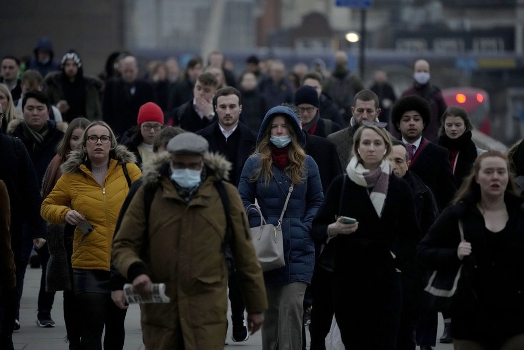Para pekerja berjalan di Jembatan London menuju kawasan pusat bisnis kota London pada jam sibuk pagi hari di London, Inggris, 24 Januari 2022. Perhitungan kantor berita Reuters, Kamis (14/4/2022), mencatat, virus Covid-19 telah menjangkiti lebih dari 500 juta penduduk dunia. 
