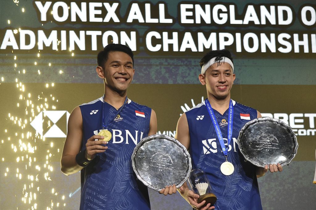 Indonesia's Fajar Alfian and Muhammad Rian Ardinanto,right, pose with trophy after winning the men's double final match against Indonesia's Mohammad Ahsan and Hendra Setiawan in the All England Open Badminton Championships at the Utilita Arena in Birmingham, England, Sunday, March 19, 2023. 